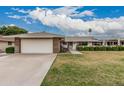 Single level home boasts mature landscaping, two car garage and neutral color palette at 9606 W Long Hills Dr, Sun City, AZ 85351