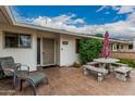Covered patio with seating area and table, great for entertaining or relaxing at 9606 W Long Hills Dr, Sun City, AZ 85351