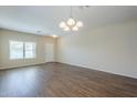 Bright and spacious living room with wood-look floors and ample natural light at 11625 N 153Rd Dr, Surprise, AZ 85379