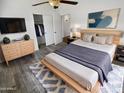 Cozy main bedroom suite with stylish decor, wood-look flooring, and a spacious closet at 14065 W Cornerstone Trl, Surprise, AZ 85374