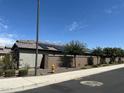 View of the house showcasing solar panels on the roof and desert landscaping on a sunny day at 15301 W Moreland St, Goodyear, AZ 85338
