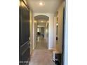 Inviting foyer with neutral walls, tile flooring, and arched openings at 15301 W Moreland St, Goodyear, AZ 85338