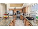 Well-equipped kitchen features stainless steel appliances and granite countertops at 16337 W Pierce St, Goodyear, AZ 85338
