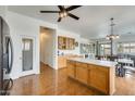 Open-concept kitchen featuring a center island, wood cabinets, and modern appliances at 16398 N Oachs Dr, Surprise, AZ 85374