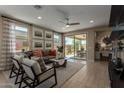 Inviting living room featuring comfortable seating, abundant windows, and access to outdoor patio at 17650 W Bajada Rd, Surprise, AZ 85387