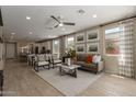 Bright living room showcasing modern furnishings, neutral tones, and seamless flow to dining area at 17650 W Bajada Rd, Surprise, AZ 85387
