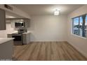 Kitchen and dining area feature wood floors, stainless appliances, and large windows at 1916 W Morningside Dr # 111, Phoenix, AZ 85023