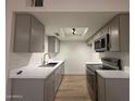 Modern kitchen features gray cabinets, stainless steel appliances, and quartz countertops at 1916 W Morningside Dr # 111, Phoenix, AZ 85023