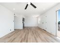 An open-concept living room with bright white walls and wood floors at 1916 W Morningside Dr # 111, Phoenix, AZ 85023
