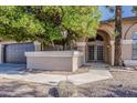 Close up on house entrance featuring an arched entryway and decorative landscaping at 1927 E Ranch Rd, Tempe, AZ 85284