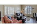 Comfortable living room featuring hardwood floors, neutral walls, and bright, shuttered windows at 1927 E Ranch Rd, Tempe, AZ 85284