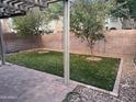 Backyard view with artificial turf, pavers, and a privacy wall at 19814 N 49Th Dr, Glendale, AZ 85308