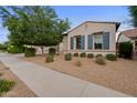 Inviting single-story home showcasing a desert front yard and a sidewalk leading to the entrance at 19905 E Apricot Ln, Queen Creek, AZ 85142