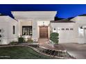Up close, this is the entrance to a home with a double-door entry, fountain and brick walkway at 2041 W Hemlock Way, Chandler, AZ 85248