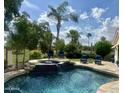 Backyard pool with lounge seating, golf course views, and manicured landscaping at 2041 W Hemlock Way, Chandler, AZ 85248