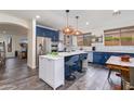 Eat-in kitchen featuring island, white countertops, breakfast bar, and stainless appliances at 20713 N 91St Dr, Peoria, AZ 85382