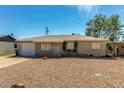Charming single-story home has a low-maintenance gravel yard and a covered front door at 2213 E Campbell Ave, Phoenix, AZ 85016