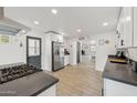 Spacious kitchen boasts stainless steel appliances, white cabinets, and dark countertops at 2321 N 30Th St, Phoenix, AZ 85008