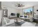 Bright and airy living room with a large window, comfortable seating, and stylish ceiling fan at 2321 N 30Th St, Phoenix, AZ 85008