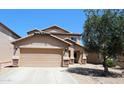 Two-story home featuring a two-car garage, desert landscaping, and a tile roof at 2434 E San Manuel Rd, San Tan Valley, AZ 85143