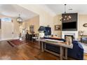 Open concept living room with hardwood floors and a fireplace at 27953 N 111Th Way, Scottsdale, AZ 85262