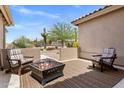Outdoor patio space with comfortable seating and a cozy fire pit at 27953 N 111Th Way, Scottsdale, AZ 85262