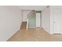 Open-concept living space with tile flooring, staircase, and neutral color palette at 286 W Palomino Dr # 103, Chandler, AZ 85225