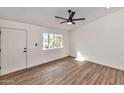 Bright living room showcasing wood floors, large window, and neutral paint at 3026 W Ross Ave, Phoenix, AZ 85027