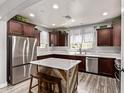 Modern kitchen with stainless steel appliances, center island, and stylish cabinetry at 3272 E Orchid Ln, Gilbert, AZ 85296