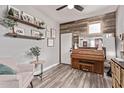 Cozy living room with piano, wood accent wall, floating shelves, and comfortable seating at 3272 E Orchid Ln, Gilbert, AZ 85296