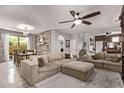 Open concept living room with modern decor, plush sectional sofa, and view of dining area and stairs at 3272 E Orchid Ln, Gilbert, AZ 85296