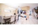Open-concept dining area features stylish decor and leads to a hallway at 33013 N Ash Tree Ln, San Tan Valley, AZ 85144
