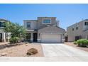 Charming home with desert landscape, two-car garage, and covered porch at 33013 N Ash Tree Ln, San Tan Valley, AZ 85144