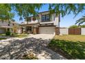 Inviting two-story home with a front porch, a two-car garage, and a lush green lawn at 3784 E Washington Ct, Gilbert, AZ 85234