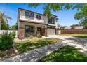 Well-maintained two-story home with a green lawn, brick accents, and an attached two-car garage at 3784 E Washington Ct, Gilbert, AZ 85234