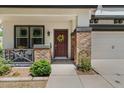 Cozy front porch with brick columns, a seating area, and a welcoming front door with a decorative wreath at 3784 E Washington Ct, Gilbert, AZ 85234
