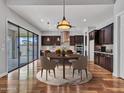 Open dining area features wood cabinets, a stylish round rug, and modern lighting fixtures at 3809 E Lynx Pl, Chandler, AZ 85249