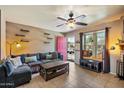 Comfortable living room featuring a ceiling fan, tile flooring, and a large window at 7977 W Wacker Rd # 220, Peoria, AZ 85381