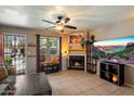 Cozy living room featuring a fireplace, ceiling fan, and tile flooring at 7977 W Wacker Rd # 220, Peoria, AZ 85381