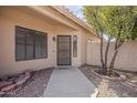 Inviting front entrance with a security door and mature landscaping at 8733 W Laurel Ln, Peoria, AZ 85345