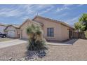 Lovely home featuring low-maintenance desert landscaping and a two-car garage at 8733 W Laurel Ln, Peoria, AZ 85345