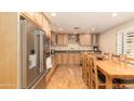 Spacious kitchen with wood cabinets, granite countertops, and stainless steel appliances at 1445 W Wood Dr, Phoenix, AZ 85029