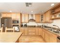 Bright kitchen features wood cabinets, granite counters, and stainless appliances at 1445 W Wood Dr, Phoenix, AZ 85029