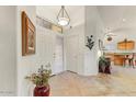 Bright entryway featuring tile floors, white walls, and decorative accents at 15695 W Earll Dr, Goodyear, AZ 85395