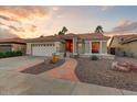 Charming home featuring desert landscaping and a two-car garage at 15695 W Earll Dr, Goodyear, AZ 85395