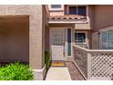 Home entrance features a neutral door, stone pathway, and privacy railing at 1633 E Lakeside Dr # 143, Gilbert, AZ 85234