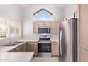 Well-lit kitchen featuring modern appliances, ample counter space, and a bright window view at 1633 E Lakeside Dr # 143, Gilbert, AZ 85234