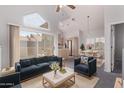 Bright living room with vaulted ceiling, fireplace, and sliding glass door to the balcony at 1633 E Lakeside Dr # 143, Gilbert, AZ 85234