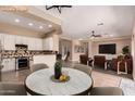 Open concept dining and living area featuring stylish decor and seamless flow into the kitchen at 16837 W Northampton Rd, Surprise, AZ 85374
