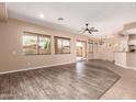 Open living area featuring tile and wood flooring, connecting the living space to the kitchen area at 16837 W Northampton Rd, Surprise, AZ 85374